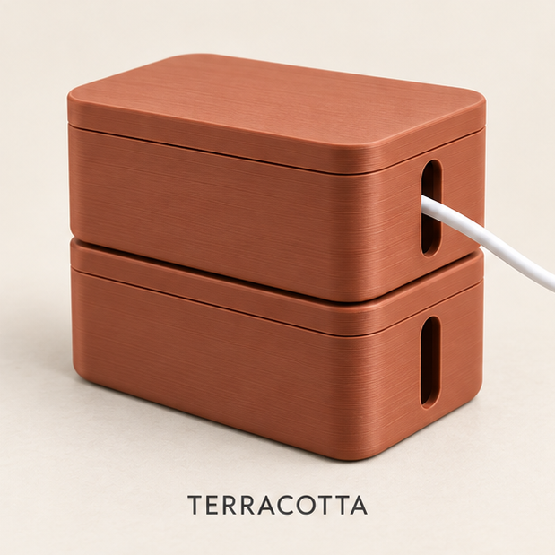 Two stacked terracotta cable boxes with lids, a white cable running out of the side slot