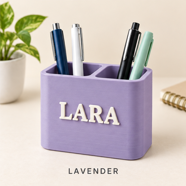 Lavender two-slot pen holder with the name LARA in raised white letters, holding pens