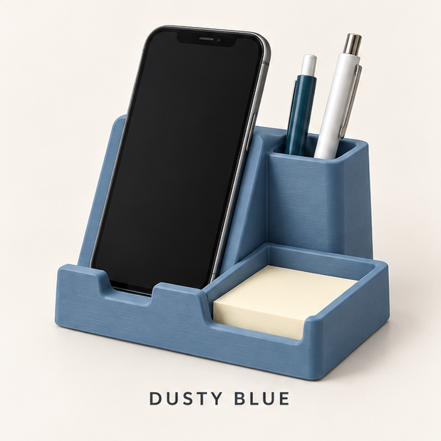 Dusty blue phone stand holding a smartphone, with a pen cup and sticky-note tray