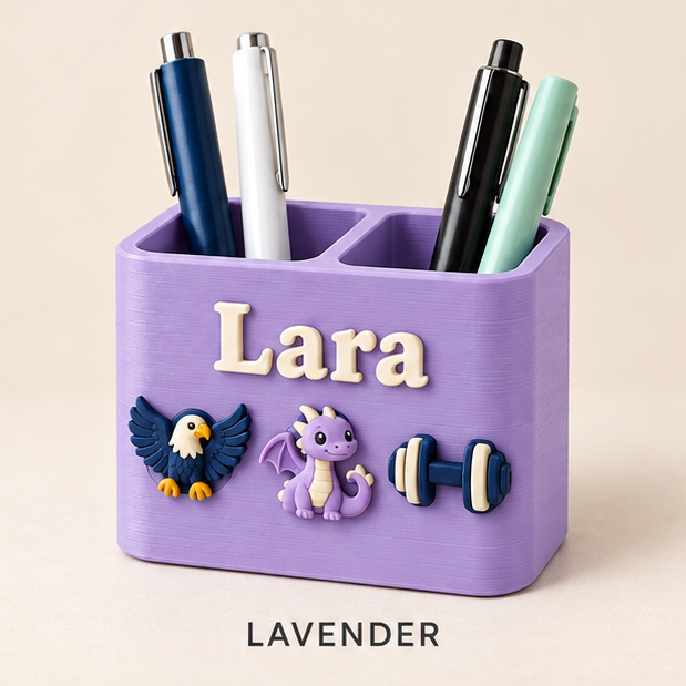 Lavender two-slot pen holder with the name Lara and eagle, dragon and dumbbell charms on the front