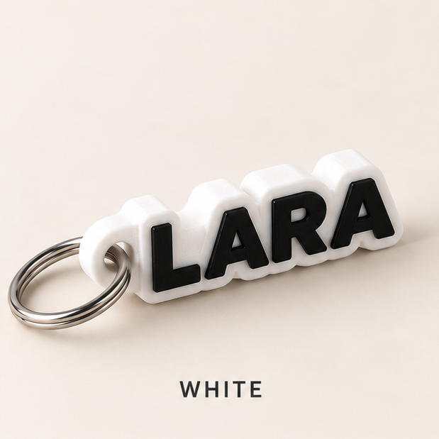 White name keychain with raised black letters spelling LARA on a silver key ring