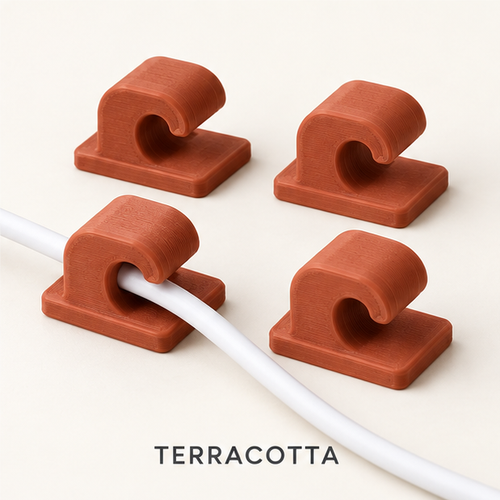 Four terracotta cable clips, two holding a white charging cable