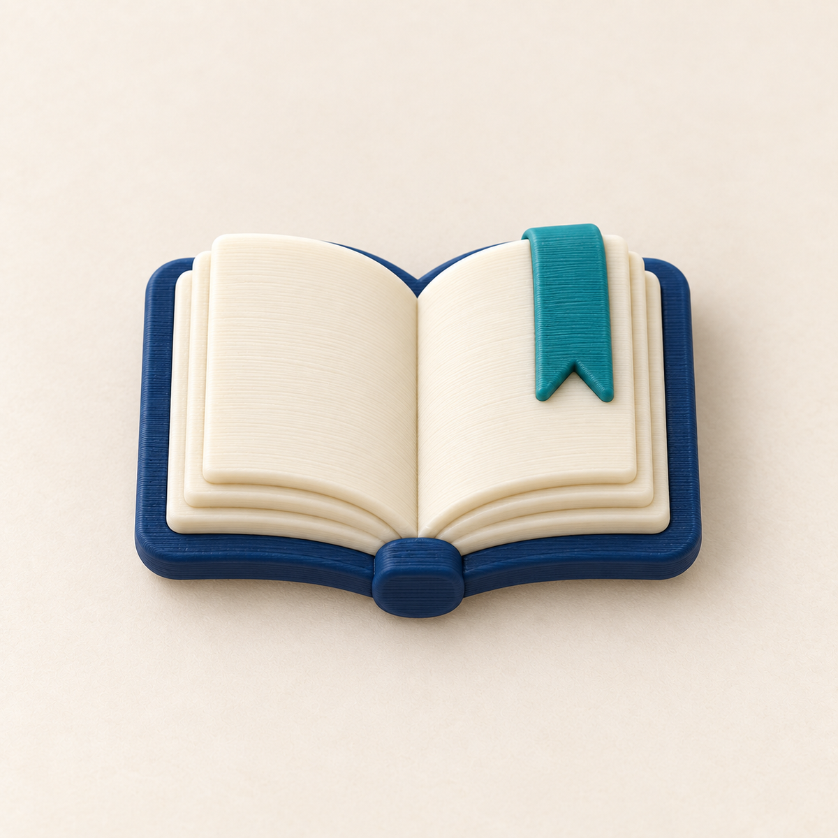 Open book charm in navy and cream with a teal bookmark