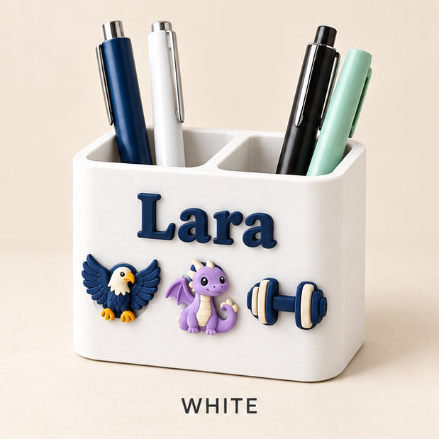 White two-slot pen holder with the name Lara in navy and eagle, dragon and dumbbell charms on the front