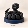 Black articulated snake coiled on a round navy base