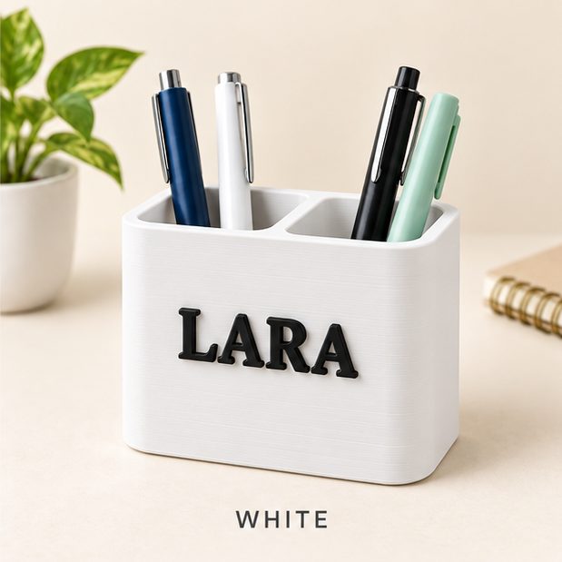 White two-slot pen holder with the name LARA in raised black letters, holding pens