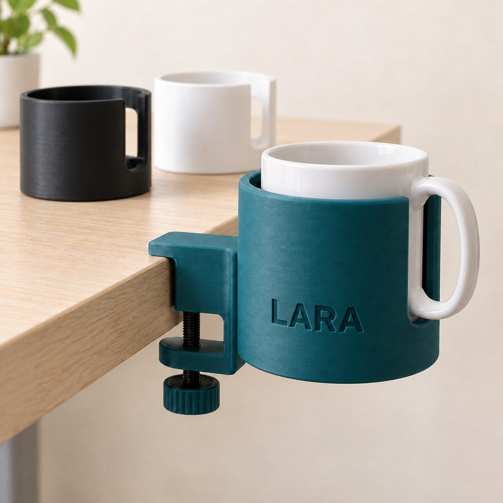 Teal clamp-on cup holder engraved LARA, fixed to a desk edge and holding a white mug