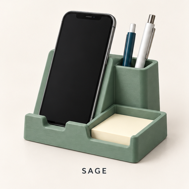 Sage green phone stand holding a smartphone, with a pen cup and sticky-note tray