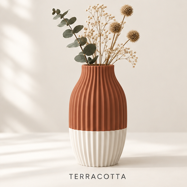 Ribbed vase, terracotta on top and cream at the base, holding dried flowers