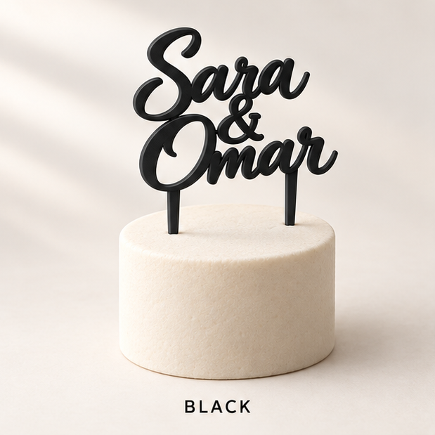 Black script cake topper reading Sara & Omar on a small white cake