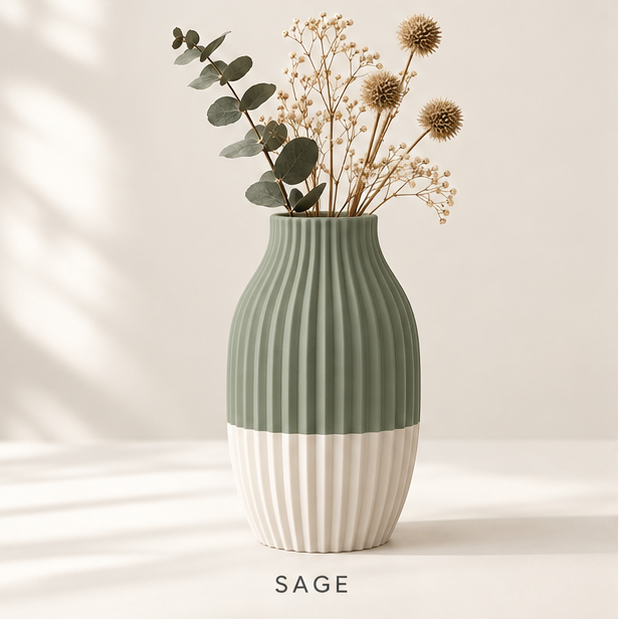 Ribbed vase, sage green on top and cream at the base, holding dried flowers